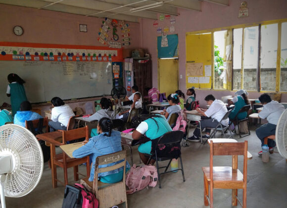 Belizean pupils working at their desks in a classroom