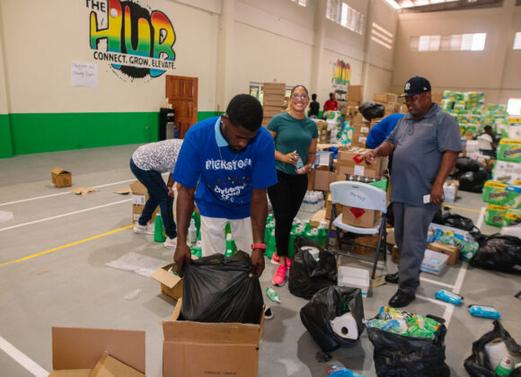 Volunteers packing relief supplies into bags at a distribution centre